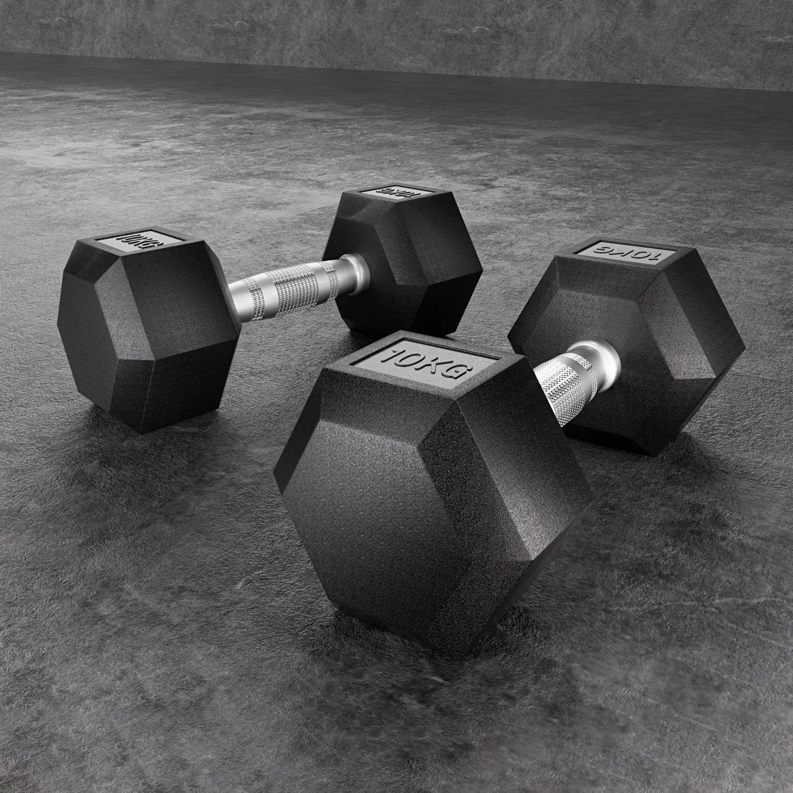 Pair of black 10kg hex dumbbells with silver textured grips on gray textured floor