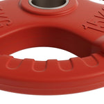 Close-up of red 15kg weightlifting bumper plate with grip handles and metal center ring