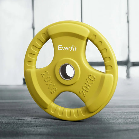 Yellow Everfit 20kg weight plate with ergonomic grip handles on gym floor