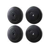 Set of two black 5kg and two 10kg weight plates for barbells isolated on white background
