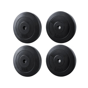 Set of two black 5kg and two 10kg weight plates for barbells isolated on white background