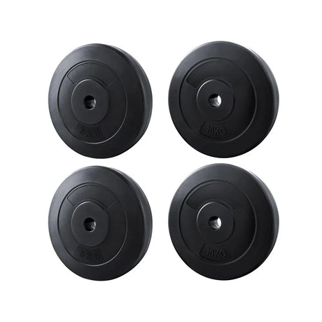Set of two black 5kg and two 10kg weight plates for barbells isolated on white background
