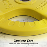 Yellow 20kg weight plate with cast iron core on marble surface, fitness equipment detail