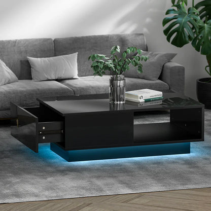 Modern black coffee table with LED lighting, glass vase, books, in a gray living room.