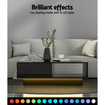 Modern black LED coffee table with color-changing lights in a gray living room setting
