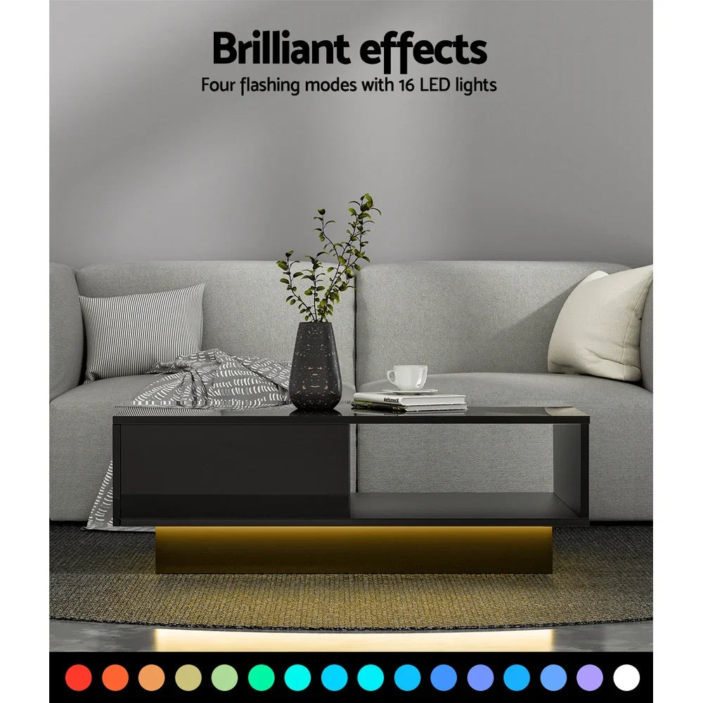 Modern black LED coffee table with color-changing lights in a gray living room setting