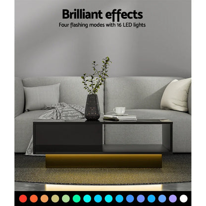 Modern black LED coffee table with color-changing lights in a gray living room setting