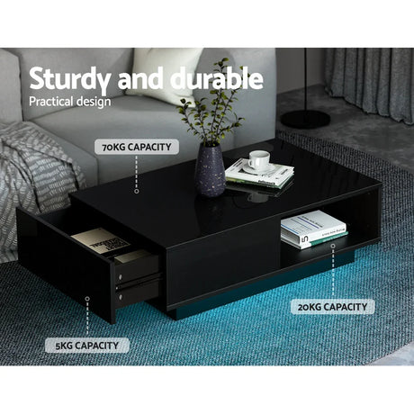 Black LED coffee table with storage drawers in modern living room, sturdy and durable design