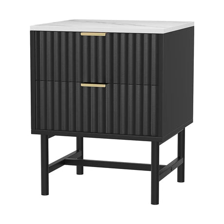Modern black nightstand with ribbed drawers, gold handles, and a white marble top