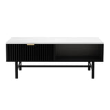 Modern black coffee table with white top, single drawer, open shelf, and gold handle