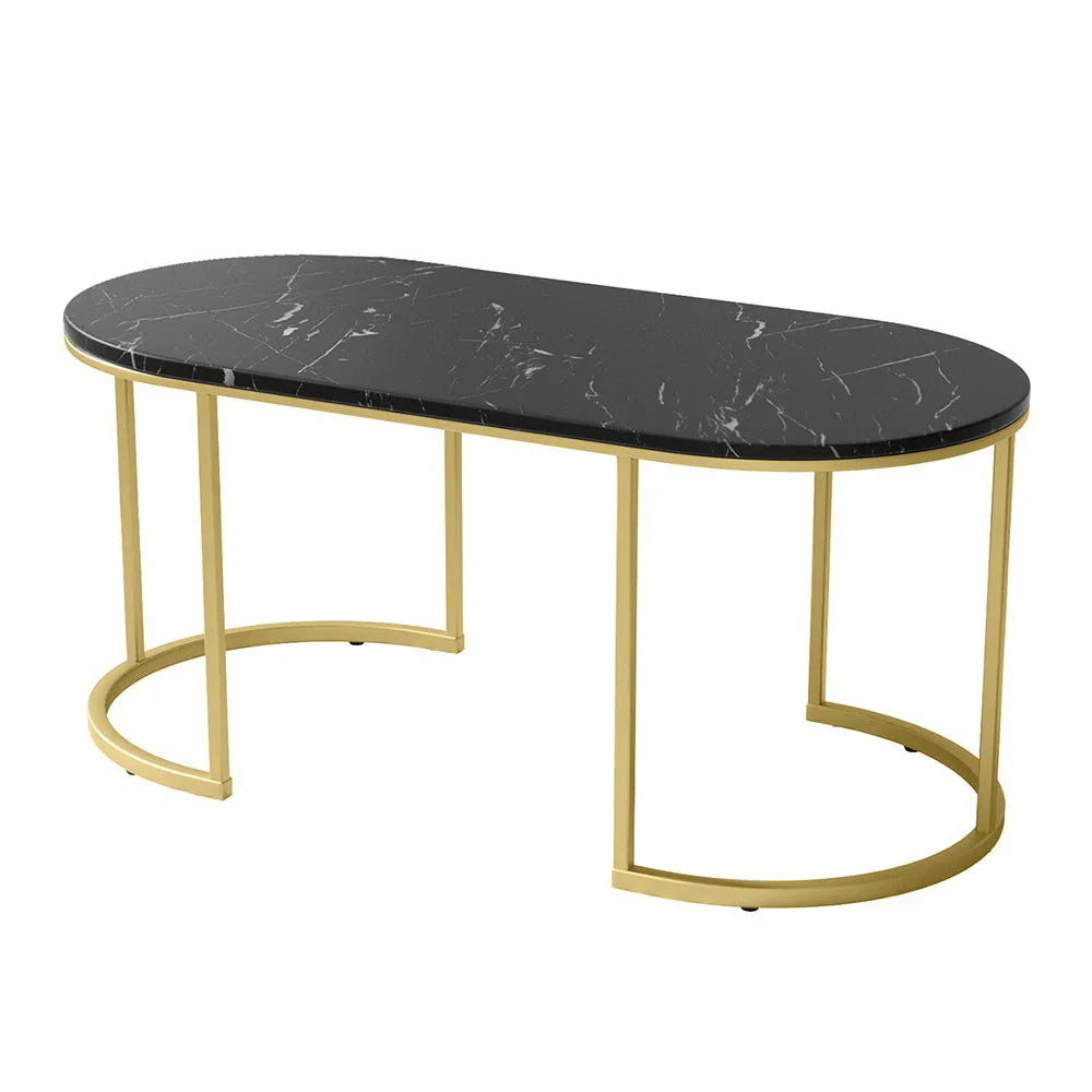 Modern oval black marble coffee table with gold metal frame on white background