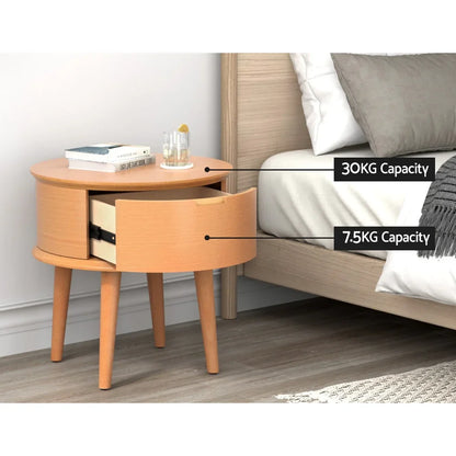 Round wooden bedside table with drawer, books, and drink beside a bed, weight capacities shown.