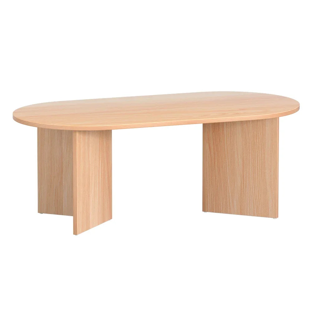 Modern oval wooden coffee table with light wood finish and panel legs