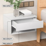 White floating bedside table with open drawer, books, vase, and weight capacity labels