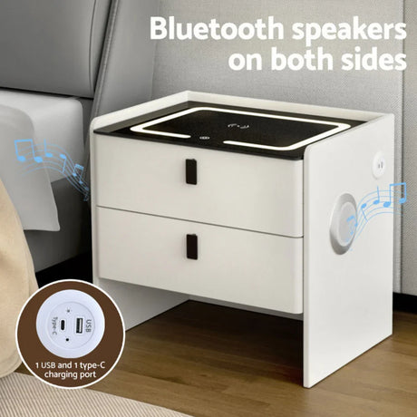 White smart nightstand with Bluetooth speakers, USB and type-C charging ports by a bed