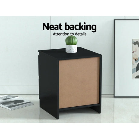Black bedside table with neat backing, small potted cactus, and modern room decor