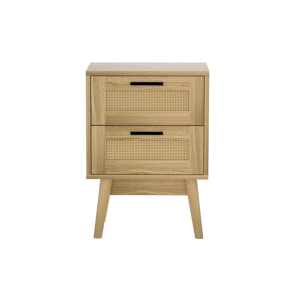 Mid-century oak nightstand with rattan drawers and black handles on white background