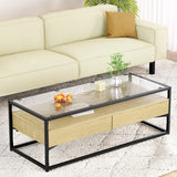 Modern glass top coffee table with wood drawers and black metal frame in living room
