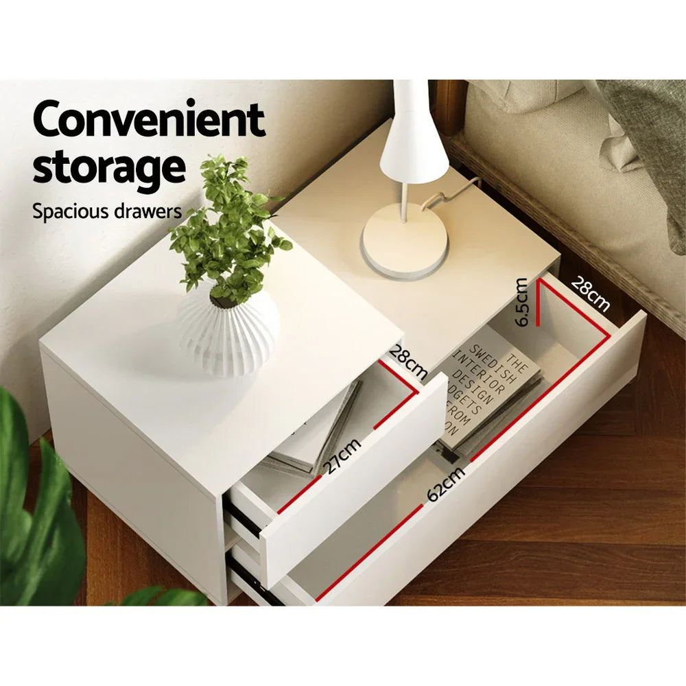 White bedside table with spacious drawers, modern lamp, and potted plant, drawer dimensions shown.