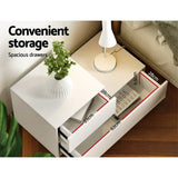 White bedside table with spacious drawers, modern lamp, and potted plant, drawer dimensions shown.