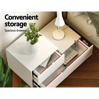 White bedside table with spacious drawers, modern lamp, and potted plant, drawer dimensions shown.