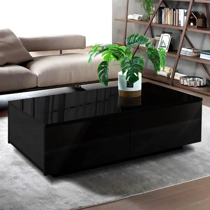 Modern black coffee table with glossy finish and potted plant in contemporary living room