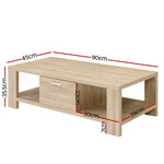 Modern wooden coffee table with drawer, open shelf, and measured dimensions in centimeters