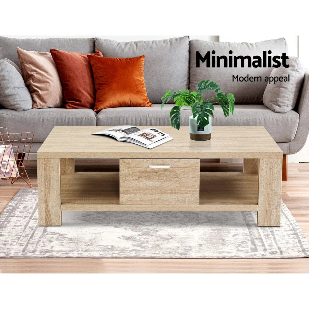 Minimalist wooden coffee table with drawer, potted plant, and magazine in modern living room