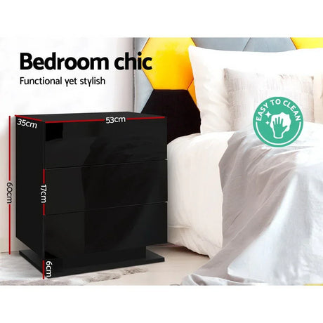 Black glossy bedside table with drawer dimensions next to a white bed, modern bedroom decor