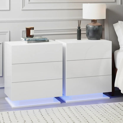 Modern white LED nightstands with drawers, vase, lamp and books in a stylish bedroom