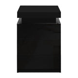 Modern black three-drawer nightstand with a glossy finish on a white background