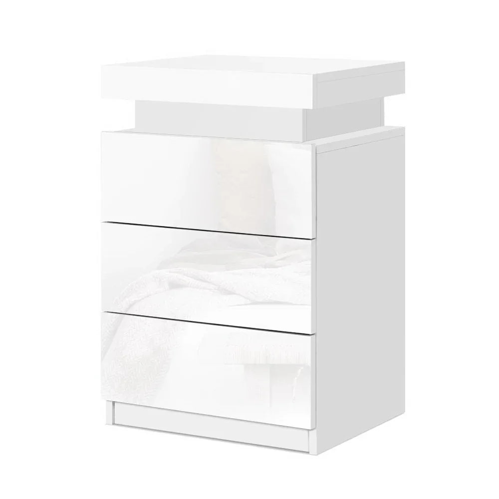 Modern white bedside table with three glossy drawers and minimalist design