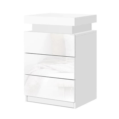 Modern white bedside table with three glossy drawers and minimalist design