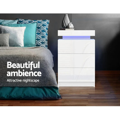 Modern white LED bedside table with blue accent in stylish bedroom with patterned pillows