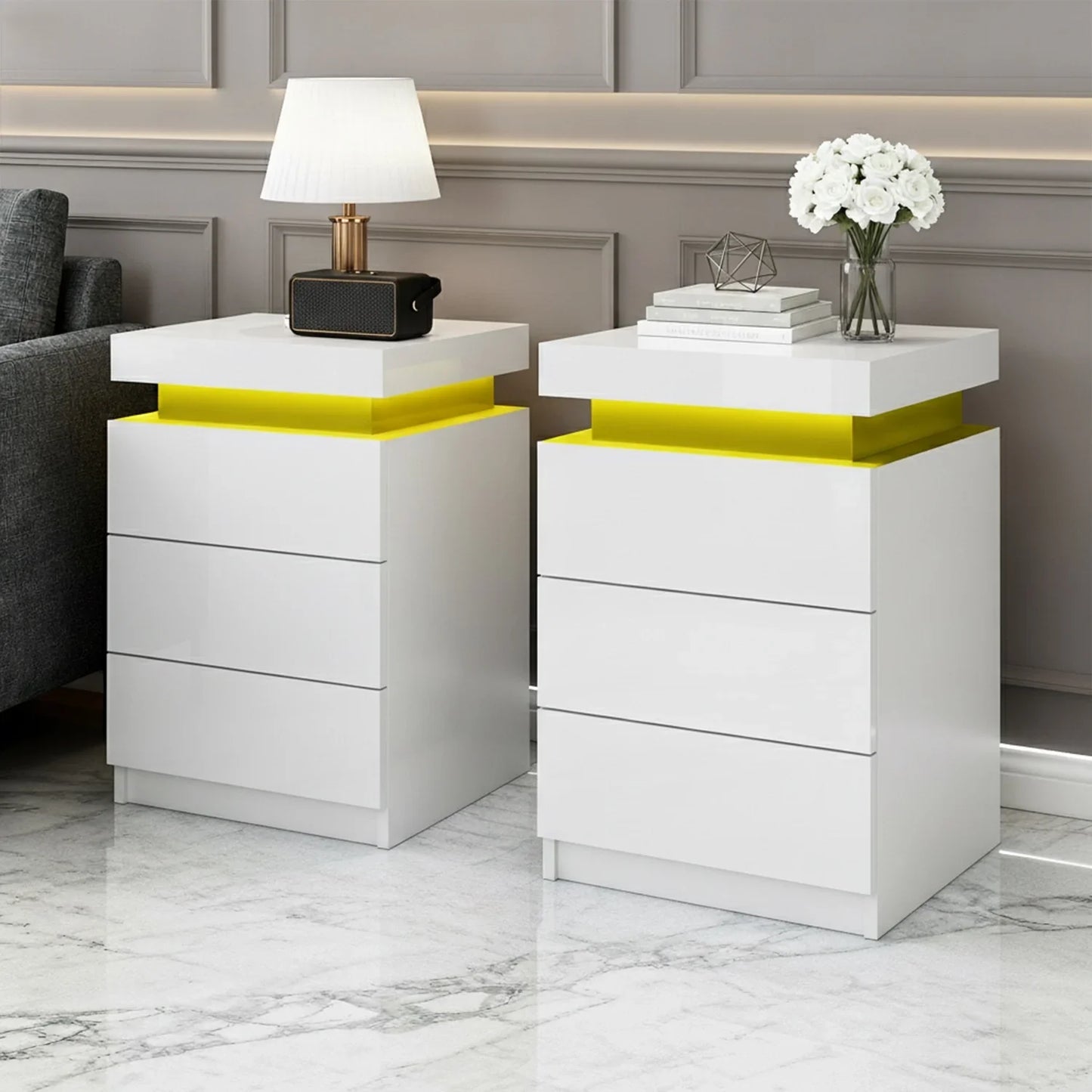 Modern white LED nightstands with yellow accent lighting, in a marble-floored room