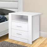 Modern white bedside table with two drawers and open shelf in a bedroom