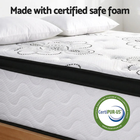 CertiPUR-US certified mattress with floral pattern, white pillows, and safe foam label