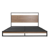 Modern bed frame with black metal and wood panel headboard and footboard, minimalist design
