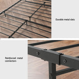 Black metal bed frame with durable slats and reinforced metal connectors on wooden floor