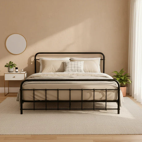 Modern black metal bed frame with beige bedding in a minimalist bedroom with plants and a round mirror