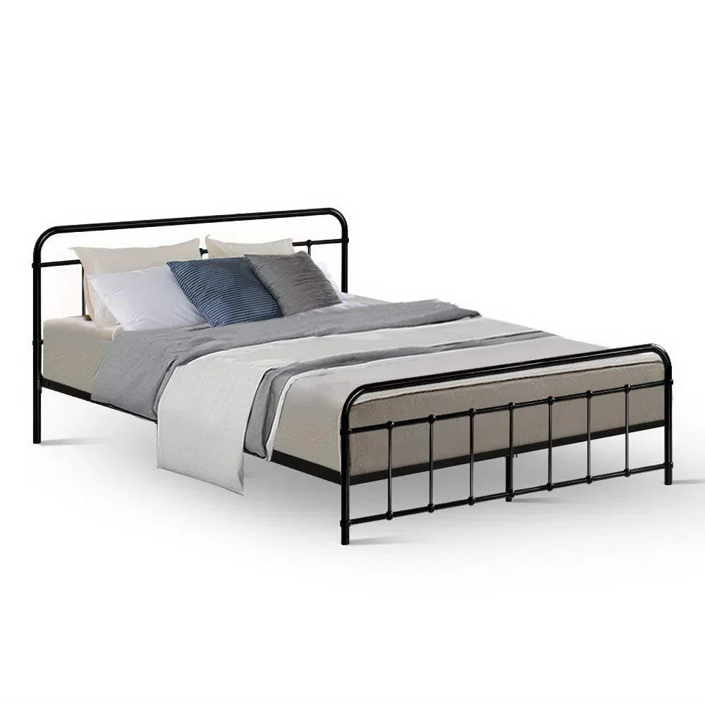 Modern black metal bed frame with gray and white bedding and assorted pillows on a white background