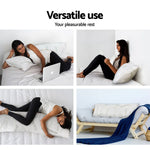 Woman using a versatile white body pillow for resting, reading, sleeping, and couch decor with a blue throw