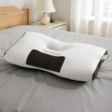 Ergonomic white memory foam pillow with black accent on gray bed, modern bedroom setting