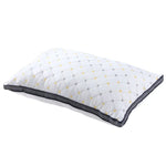 White quilted pillow with yellow and gray diamond pattern and black mesh border