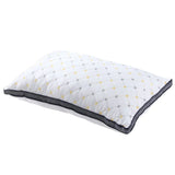 White quilted pillow with yellow and gray diamond pattern and black mesh border