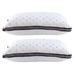 Two white pillows with black mesh trim and yellow-gray diamond pattern stacked side by side
