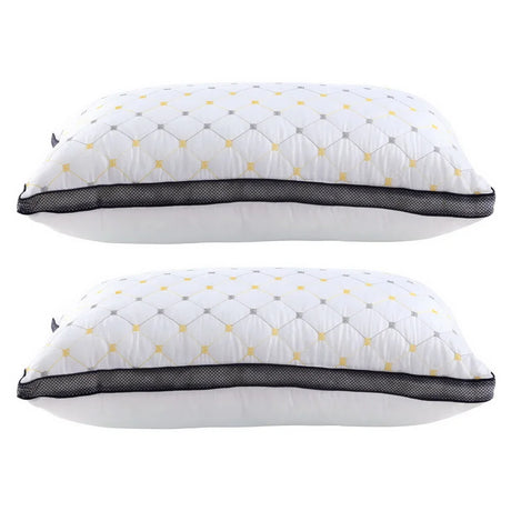Two white pillows with black mesh trim and yellow-gray diamond pattern stacked side by side