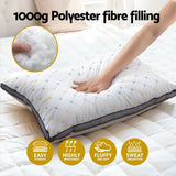 Hand pressing soft, quilted pillow with 1000g polyester fibre filling on white bed