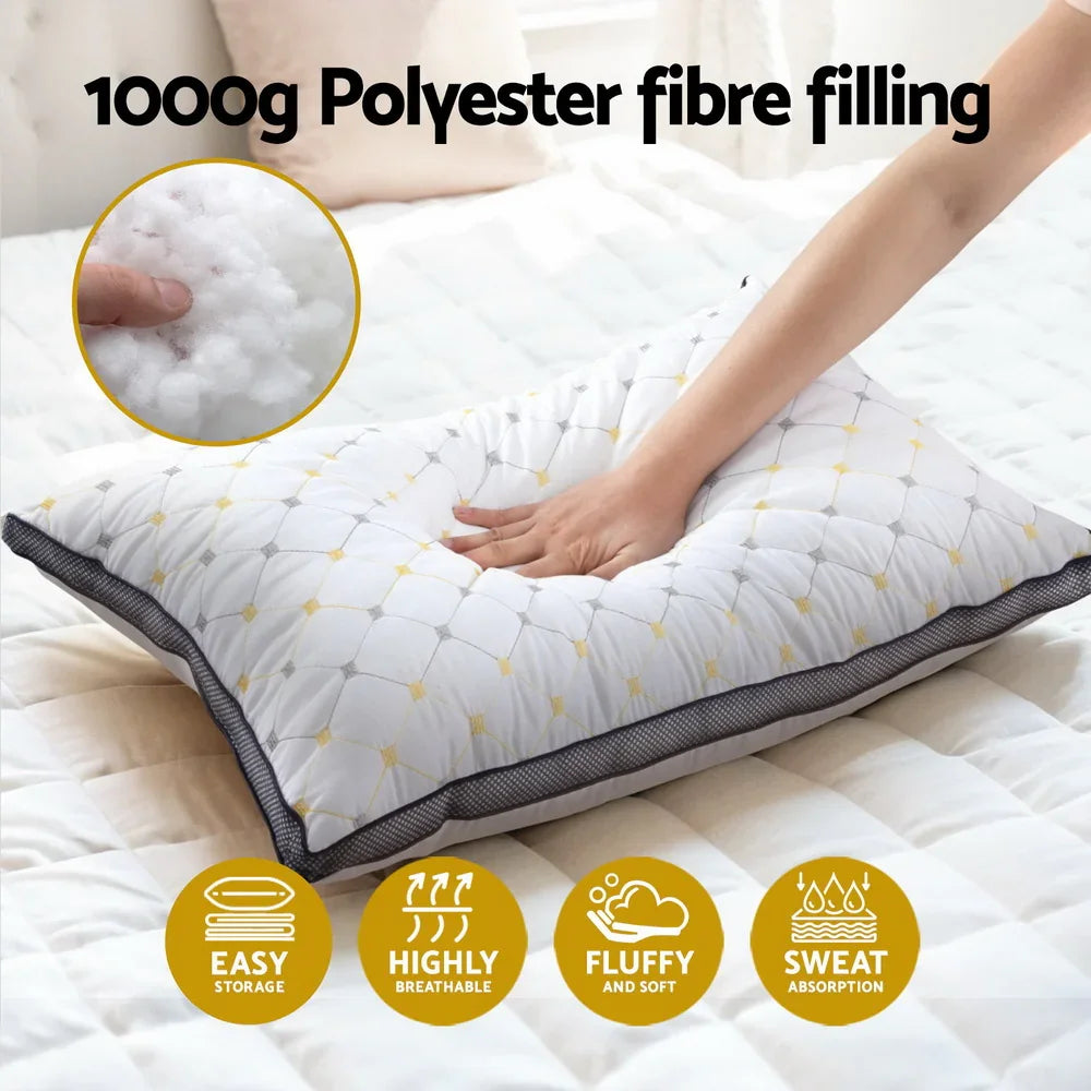 Hand pressing soft, quilted pillow with 1000g polyester fibre filling on white bed