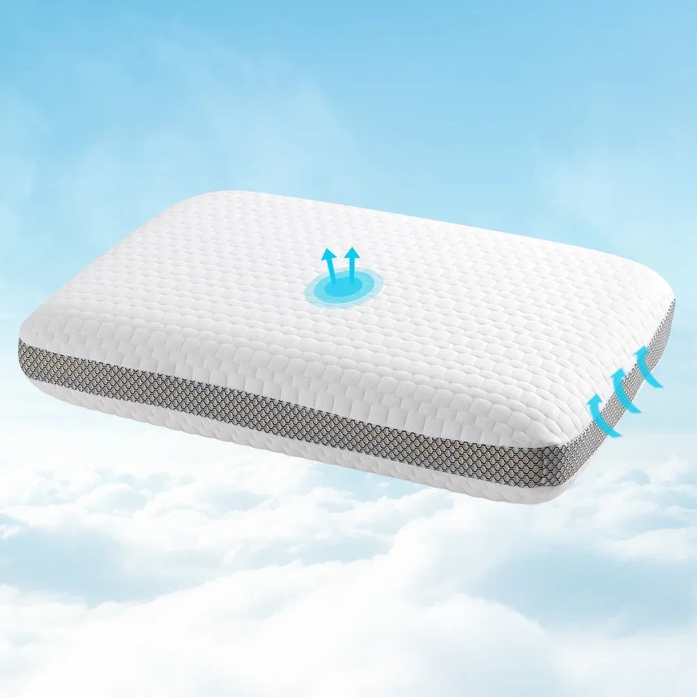 White ergonomic pillow with breathable mesh sides floating above clouds, showing airflow arrows